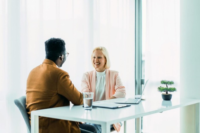 Business people discussing work-related topics, sitting at a desk